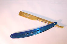 Load image into Gallery viewer, This stunning eye catcher razor. Its colors gives it that Royalty look. With its royal blue and gold stainles steel finish makes it happen.It has great wieght and very durable. Awesome for crisp hairlines, clean shaves, beard trims , and eyebrow archeing. This razor uses a double edge blade cut inhalf or a single edge blade..